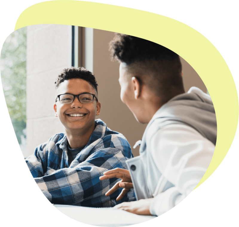 Two boys talking in a classroom